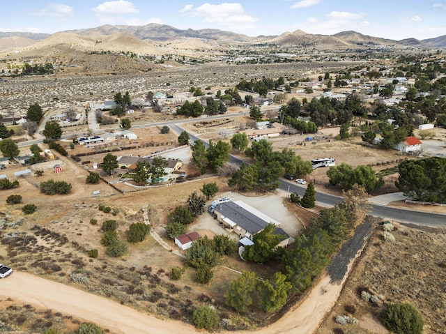 birds eye view of property featuring a desert view, a mountain view, and a rural view