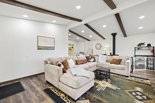 living room featuring a wood stove, wood finished floors, baseboards, recessed lighting, and vaulted ceiling with beams