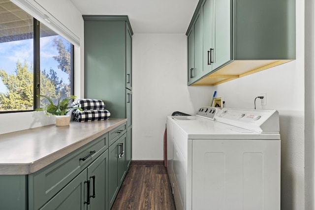 laundry room with baseboards, washing machine and dryer, dark wood-style floors, and cabinet space
