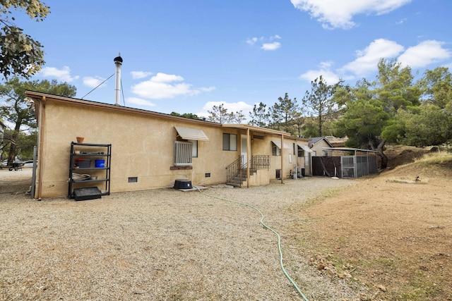 back of property with crawl space and cooling unit