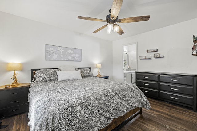bedroom featuring a ceiling fan, dark wood-style floors, and connected bathroom