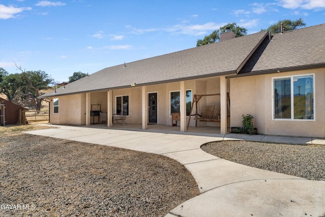 18551 Jacks Hill Rd, Tehachapi, CA 93561 - rear view of property with stucco siding, a shingled roof, a chimney, and a patio