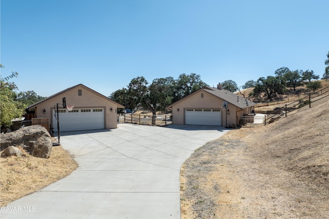 18551 Jacks Hill Rd, Tehachapi, CA 93561 - ranch-style house with stucco siding, a garage, and driveway