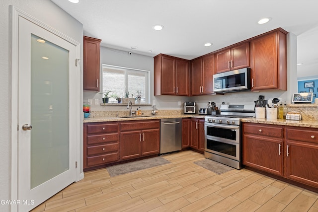 18551 Jacks Hill Rd, Tehachapi, CA 93561 - kitchen featuring stainless steel appliances, light wood-type flooring, light stone counters, and recessed lighting