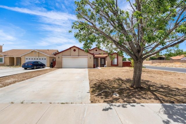 3243 Geri Ct, Rosamond, CA 93560 - view of front of property featuring an attached garage, driveway, and stucco siding
