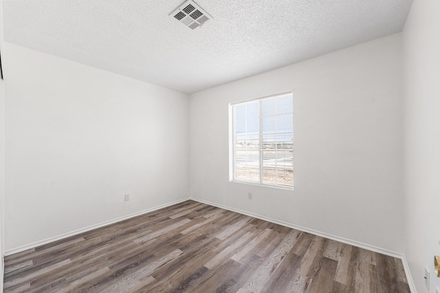 3243 Geri Ct, Rosamond, CA 93560 - empty room with wood finished floors, a textured ceiling, and baseboards