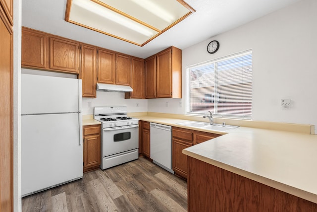 3243 Geri Ct, Rosamond, CA 93560 - kitchen featuring white appliances, under cabinet range hood, a sink, brown cabinets, and dark wood-style floors