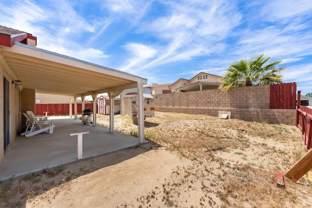 3243 Geri Ct, Rosamond, CA 93560 - fenced backyard with a storage shed, a patio area, and an outbuilding