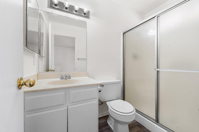 3243 Geri Ct, Rosamond, CA 93560 - full bathroom featuring toilet, wood finished floors, a shower with shower door, and vanity
