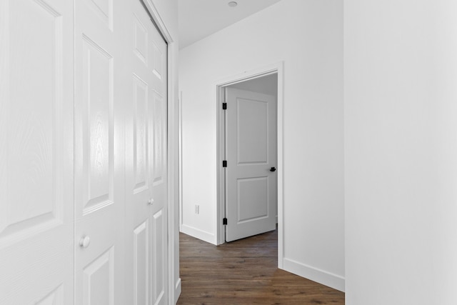 hallway with dark wood-style floors and baseboards