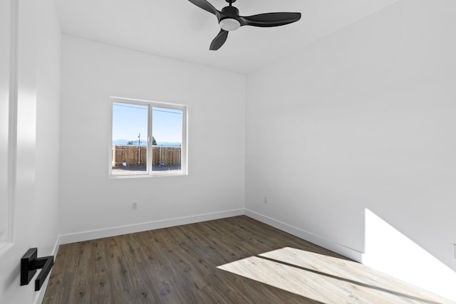 unfurnished room featuring baseboards, ceiling fan, and wood finished floors