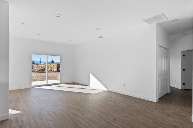 unfurnished living room with recessed lighting, visible vents, baseboards, and wood finished floors