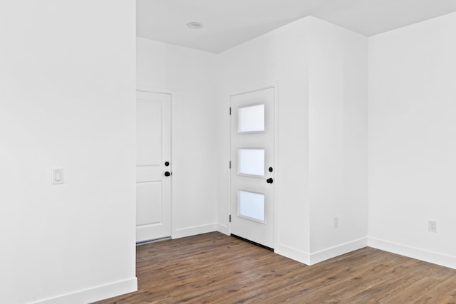 entryway featuring wood finished floors and baseboards