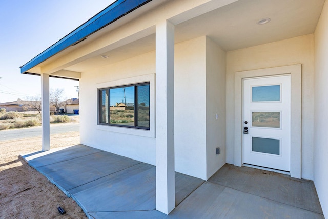 property entrance with stucco siding