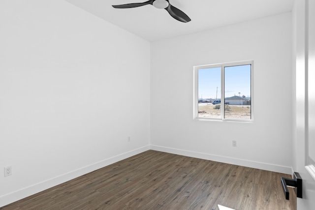 empty room with a ceiling fan, baseboards, and dark wood-style floors