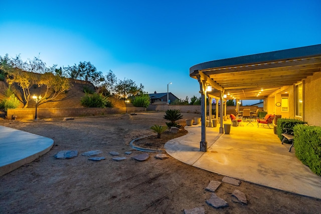 patio terrace at dusk featuring an outdoor hangout area