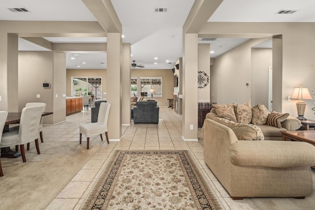 living room featuring ceiling fan and light tile patterned flooring