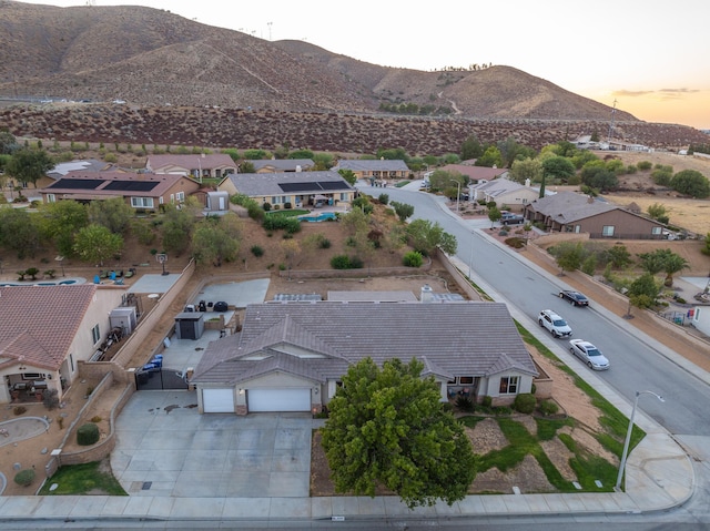 aerial view at dusk featuring a mountain view