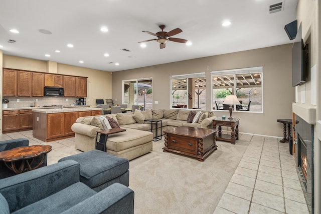 living room featuring ceiling fan and light tile patterned floors