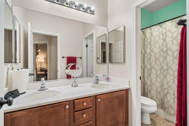 bathroom with tile patterned floors, vanity, and toilet