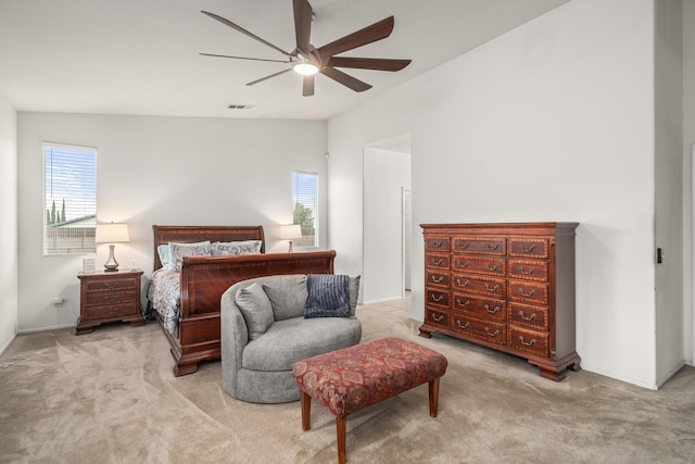 bedroom featuring ceiling fan, light colored carpet, and lofted ceiling