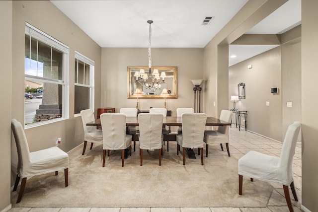 dining room featuring light tile patterned floors and an inviting chandelier