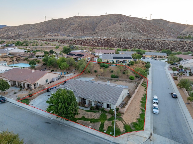 birds eye view of property with a mountain view