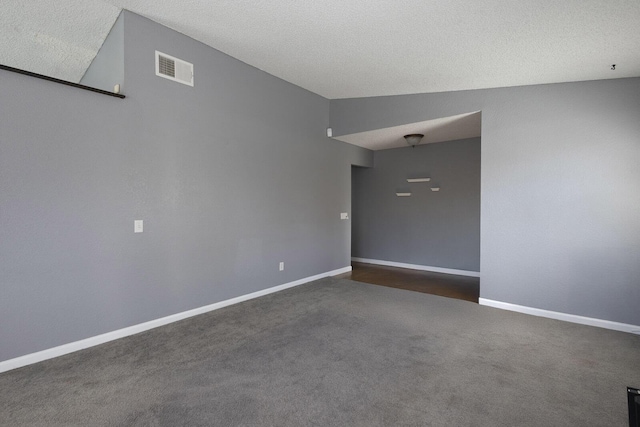 carpeted spare room with baseboards and visible vents