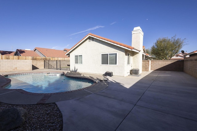 view of pool with cooling unit, a fenced backyard, a patio area, and a fenced in pool