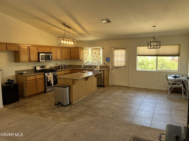 13320 E Ave W6, Pearblossom, CA 93553 - kitchen with stainless steel appliances, light tile patterned flooring, a center island, brown cabinets, and decorative light fixtures
