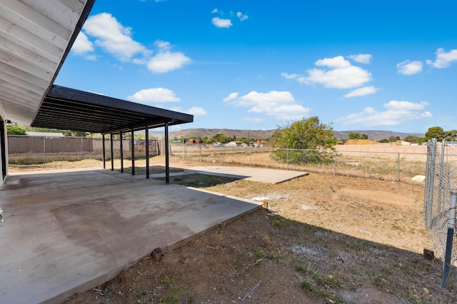 view of yard featuring a mountain view and a fenced backyard