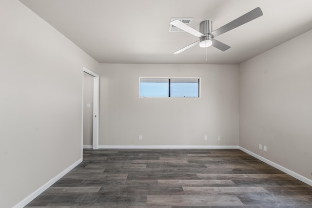 spare room featuring a ceiling fan, visible vents, wood finished floors, and baseboards