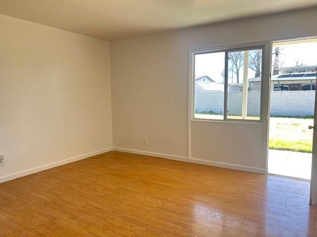 unfurnished room featuring light wood-style flooring and baseboards