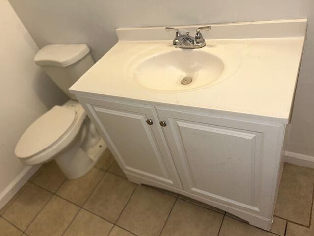 bathroom with tile patterned floors, toilet, vanity, and baseboards