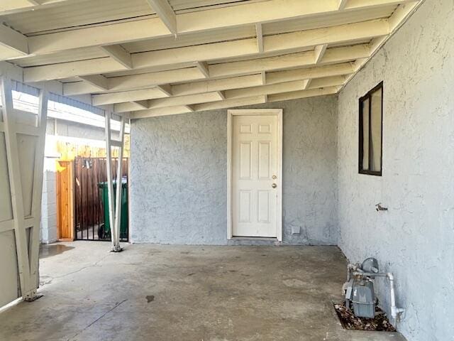 entrance to property with fence and stucco siding