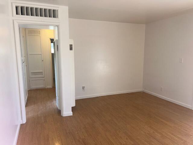 spare room with dark hardwood / wood-style floors