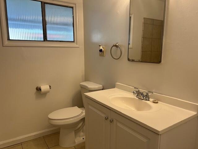 bathroom featuring tile patterned floors, toilet, vanity, and baseboards