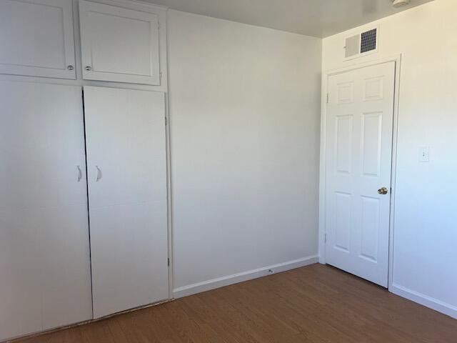 spare room with wood-type flooring