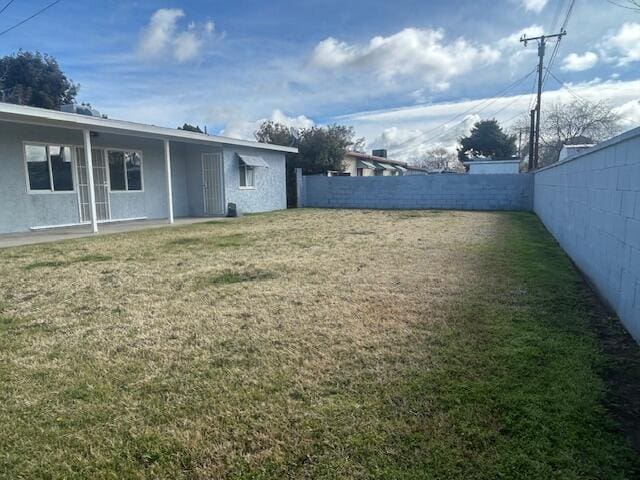 view of yard with a fenced backyard