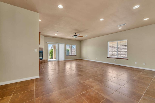 empty room with tile patterned floors, baseboards, visible vents, ceiling fan, and recessed lighting