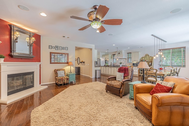 living room featuring dark hardwood / wood-style floors and ceiling fan