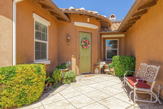 doorway to property featuring a patio area