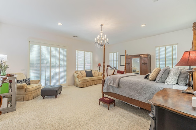 bedroom with carpet floors and a notable chandelier