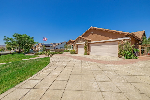 view of front of property featuring a front yard and a garage