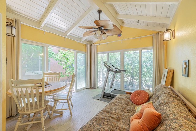 sunroom with lofted ceiling with beams and ceiling fan