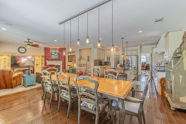 dining room with hardwood / wood-style flooring and ceiling fan