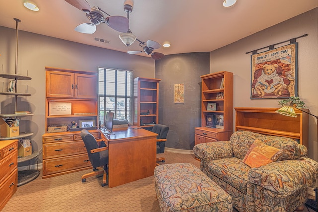 carpeted office space featuring ceiling fan