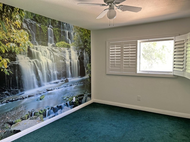 unfurnished room with ceiling fan and dark carpet