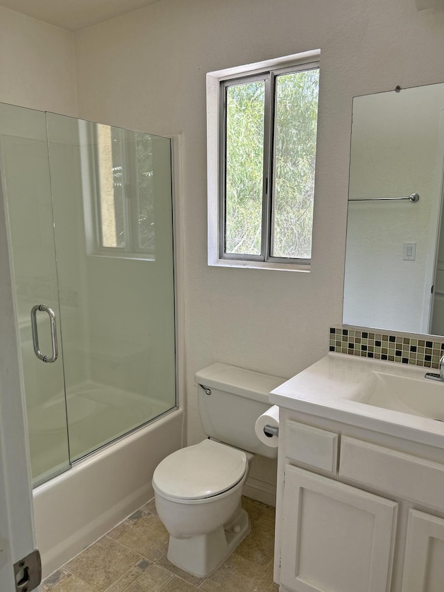 full bathroom with vanity, toilet, and bath / shower combo with glass door