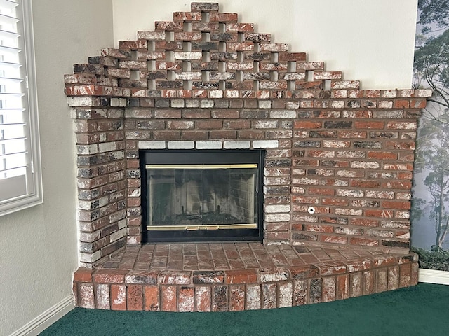 interior details with carpet floors and a fireplace